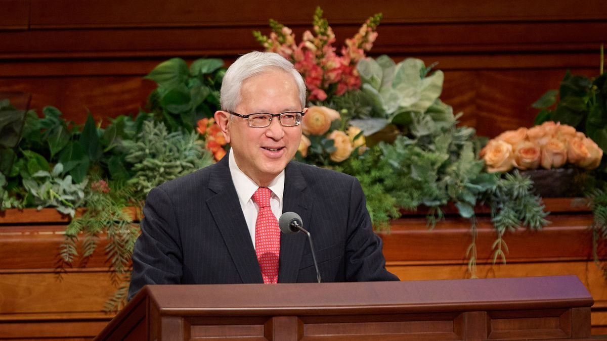 Elder Gerrit W. Gong smiling at the general conference pulpit