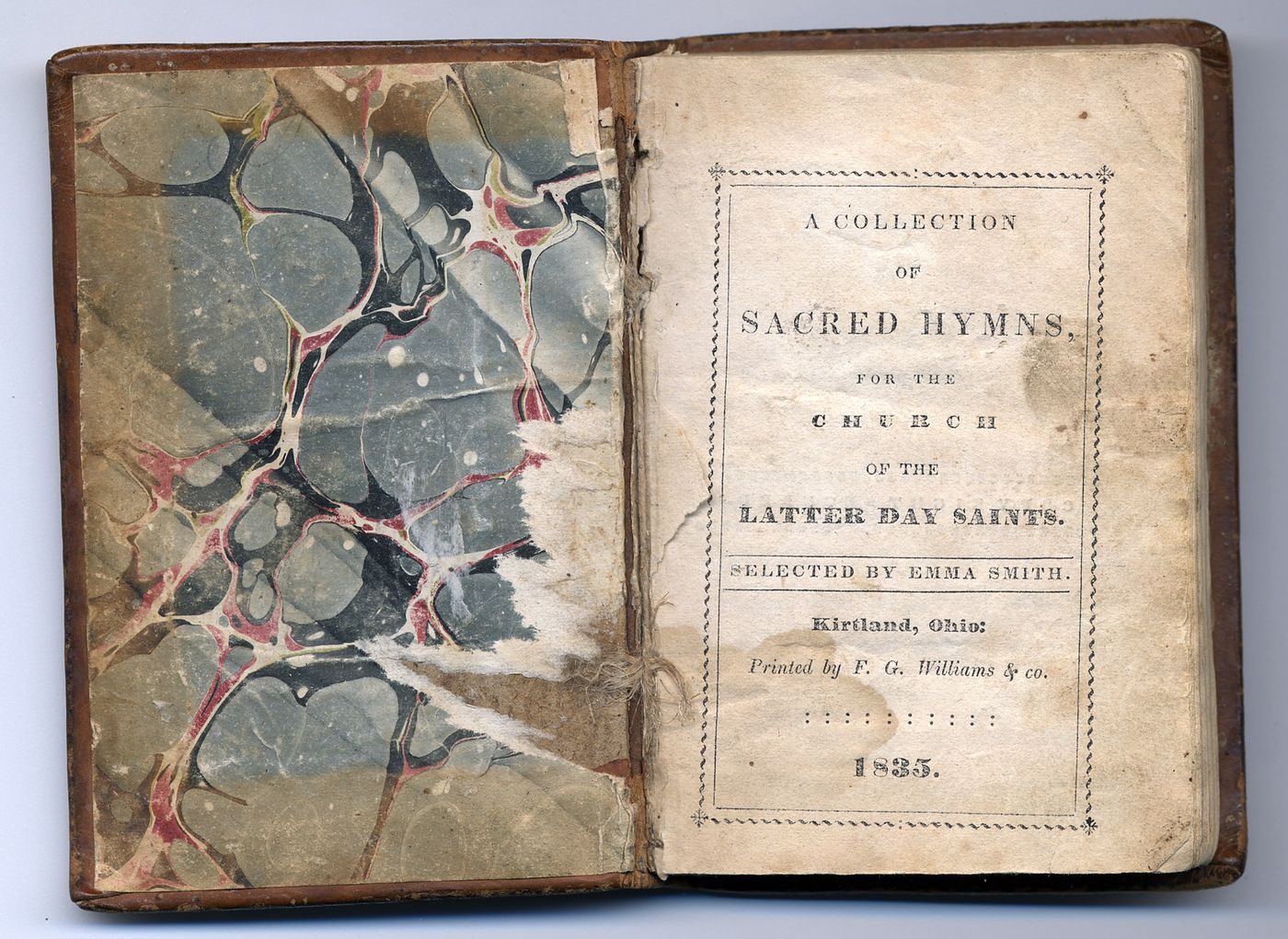 An open copy of the 1835 hymnal, A Collection of Sacred Hymns, selected by Emma Smith