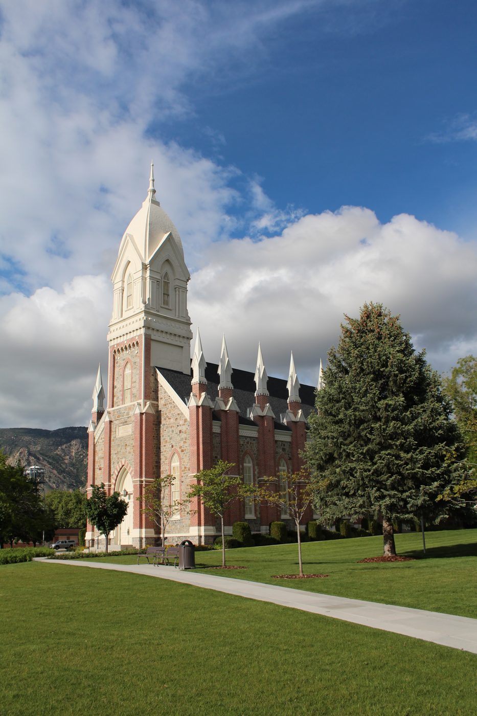 The brick Brigham City Tabernacle with its tall white tower under a blue sky