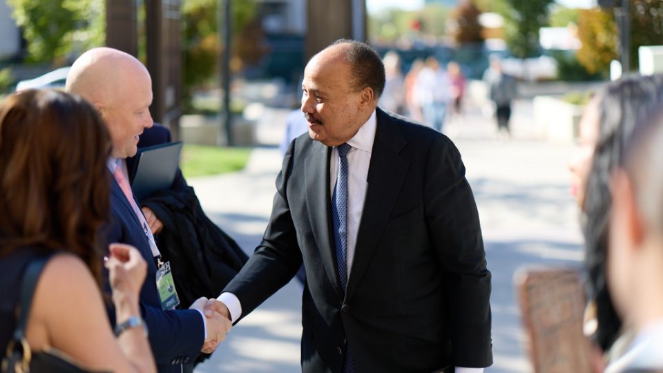 Two guests shaking hands outdoors at the G20 Interfaith Forum