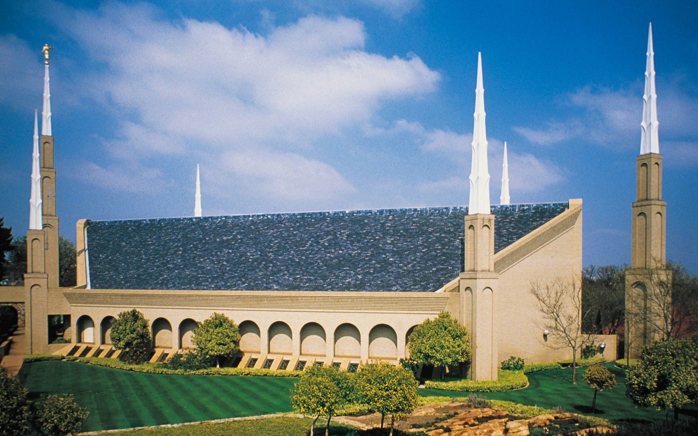 The Johannesburg South Africa Temple with its tall white spires, arched walkway and green lawn