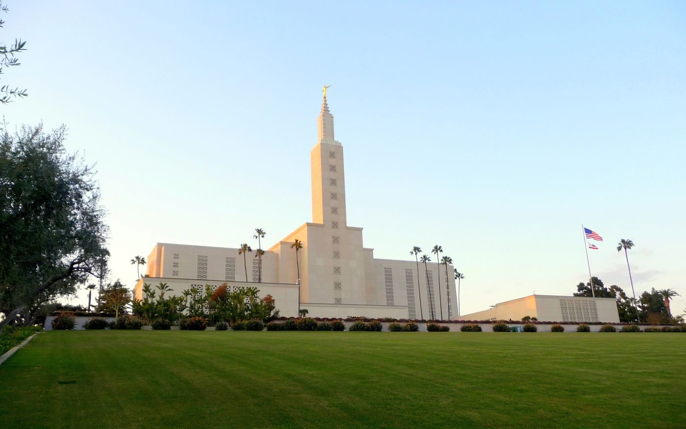 The Los Angeles California Temple with its tall tower above a wide green lawn