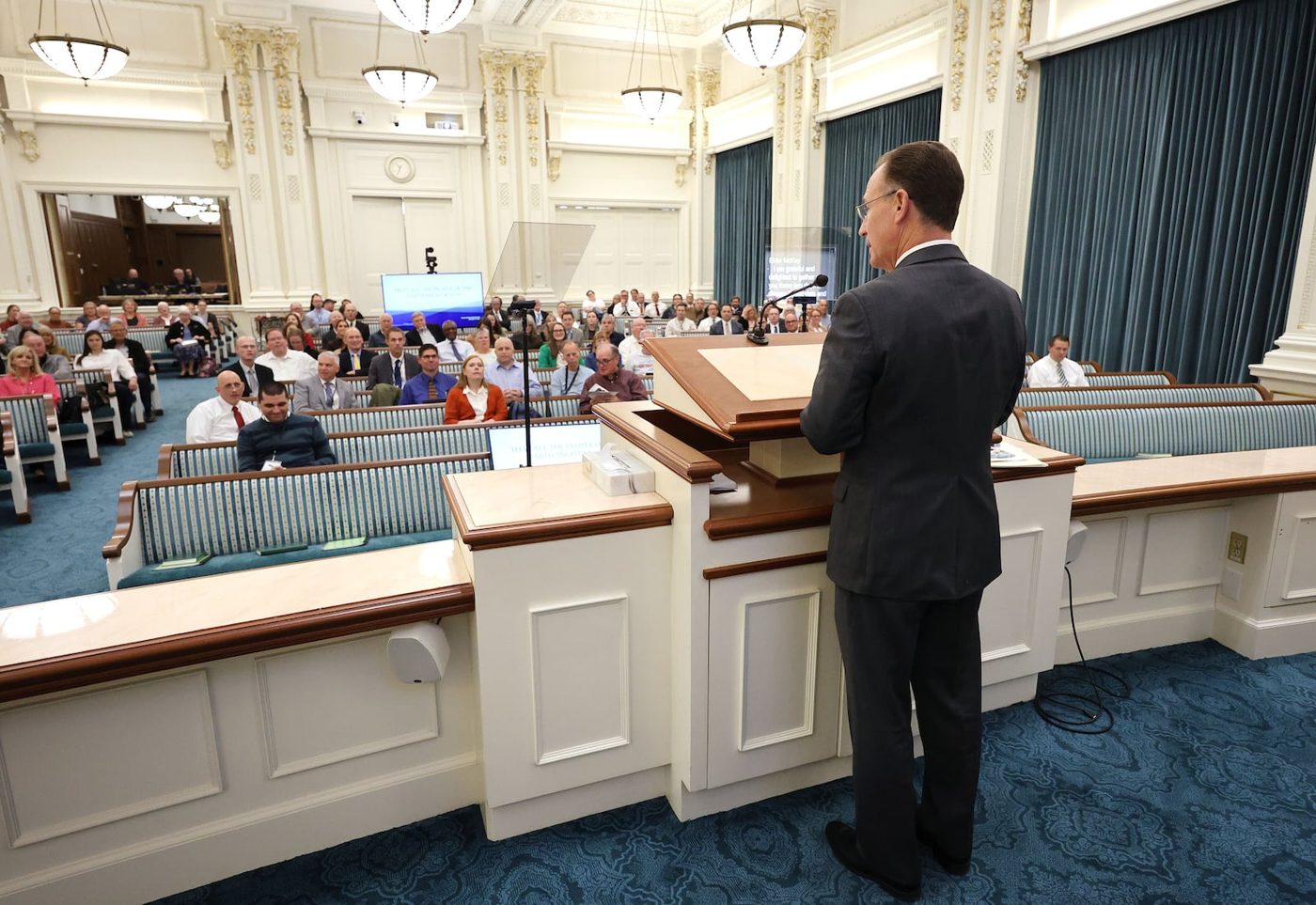 Elder Kyle S. McKay speaking at the pulpit during the Church History Symposium