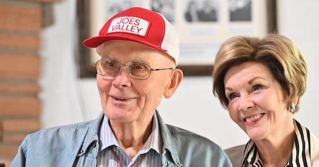 President Dallin H. Oaks in a red cap and Sister Kristen Oaks smiling at their family reunion