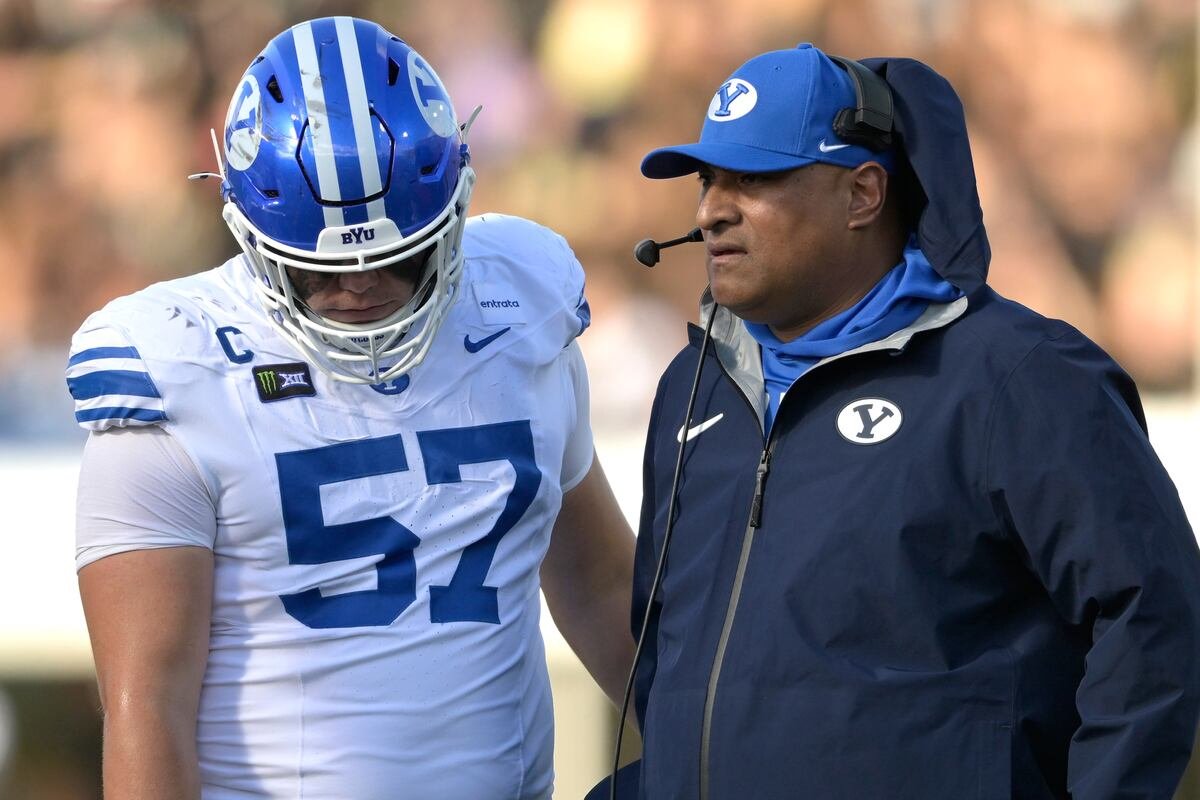 BYU head coach Kalani Sitake talks with defensive tackle Keanu Tanuvasa during the first half at UCF
